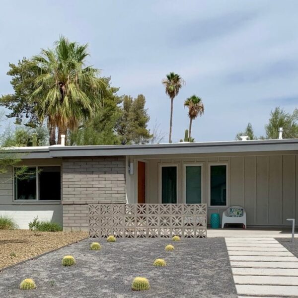 Mid-century modern home in Marion Estates Phoenix with breeze block, low roofline, carport, desert landscaping, and Camelback Mountain in the background.
