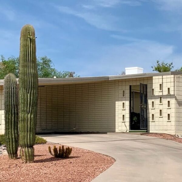 Mid-century modern home in Marion Estates Phoenix with decorative block facade, low roofline, cactus landscaping, carport, and desert modern design.