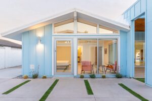 Before and after of a Scottsdale home showing conversion of a carport into a vaulted primary suite addition with clerestory windows and modern architecture.