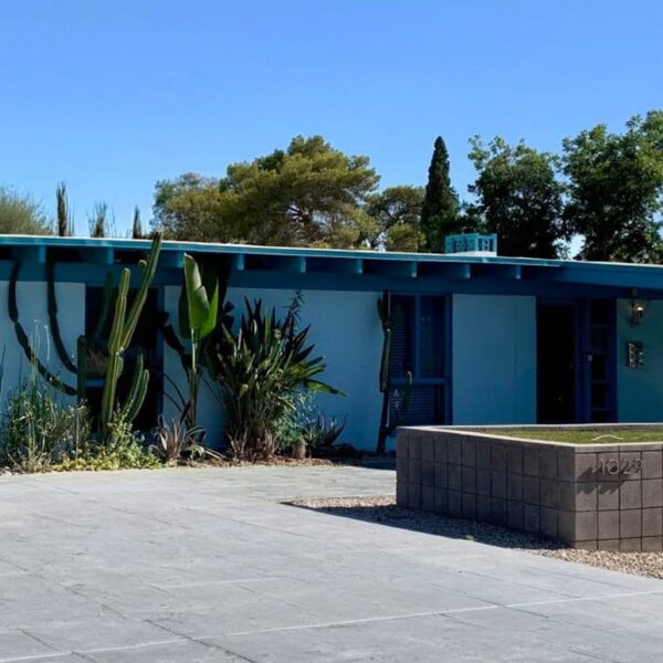 Ralph Haver mid-century modern home in Marlen Grove Phoenix with blue exterior, breeze block, low roofline, cactus landscaping, and desert modern design.