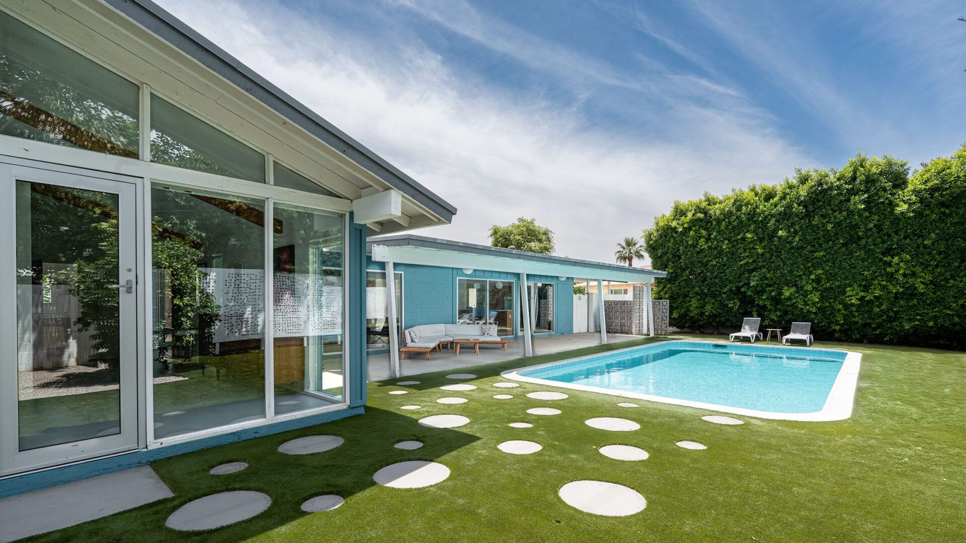 Mid-century modern renovation in Scottsdale with updated exterior architecture, desert landscaping, and clean modern lines.