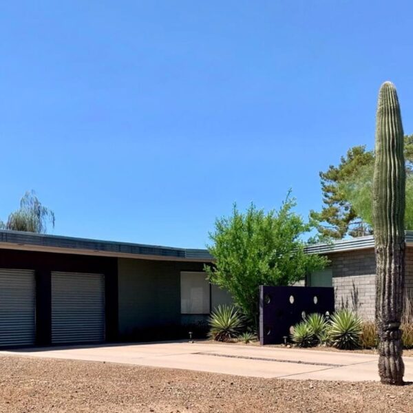 Al Beadle mid-century modern home in Paradise Gardens Phoenix with circular breeze block, low roofline, cactus landscaping, garage, and desert modern design.