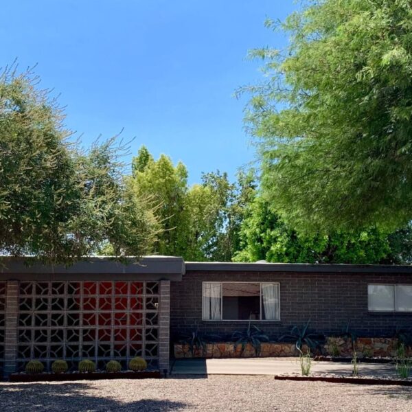 Ralph Haver mid-century modern home in Town and Country Paradise Phoenix with breeze block, stone detail, low roofline, mature trees, and desert landscaping.