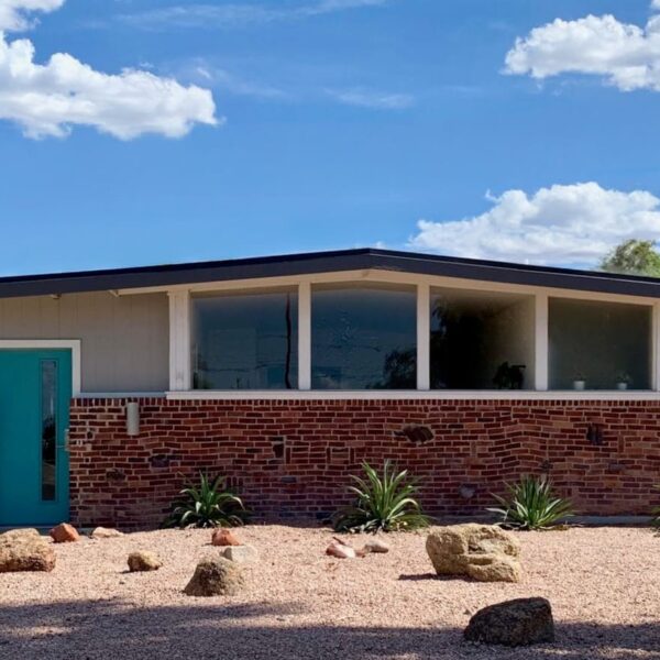 Ralph Haver mid-century modern home in Town and Country Scottsdale with clinker brick, turquoise front door, low roofline, clerestory windows, and desert landscaping.