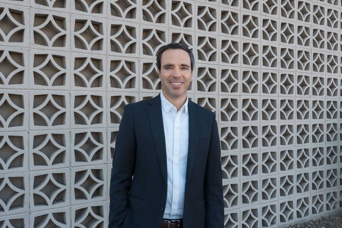 Ryan Smith of Mid Mod Phoenix standing in front of a breeze block wall in Scottsdale.