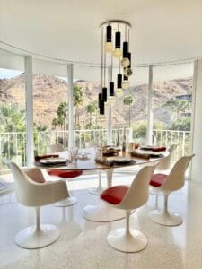 Mid-century modern dining room with terrazzo floors, Tulip chairs and floor-to-ceiling windows.